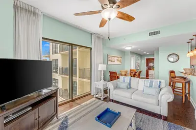 a living room with a flat screen tv and a couch at Origin 1605 - Two Bedroom - Partial Gulf View by Beach Haven Vacation Rentals in Panama City Beach