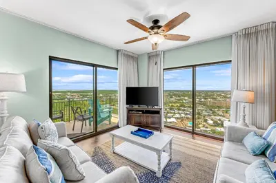 a living room with a couch and a tv at Origin 1605 - Two Bedroom - Partial Gulf View by Beach Haven Vacation Rentals in Panama City Beach