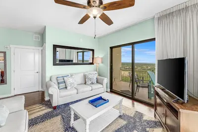 a living room with a couch and a flat screen tv at Origin 1605 - Two Bedroom - Partial Gulf View by Beach Haven Vacation Rentals in Panama City Beach