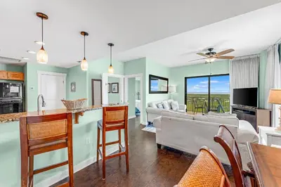 a kitchen and living room with a couch and a table at Origin 1605 - Two Bedroom - Partial Gulf View by Beach Haven Vacation Rentals in Panama City Beach
