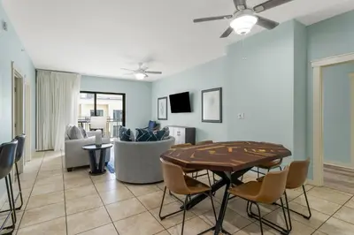 a living room with a table and a couch at Origin 1408 - Two Bedroom - Pool and Gulf View in Panama City Beach