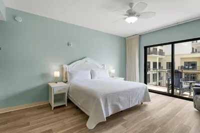 a bedroom with a white bed and a balcony at Origin 1408 - Two Bedroom - Pool and Gulf View in Panama City Beach