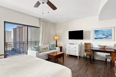 a bedroom with a bed and a desk and a tv at Origin 1329 - Studio King Gulf View - Sunrise Views by Beach Haven Vacation Rentals in Panama City Beach