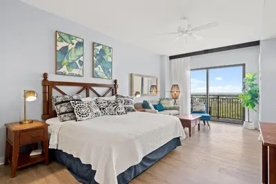 a bedroom with a bed and a balcony at Origin 1315 - Studio King - Super Cute Unit - City View by Beach Haven Vacation Rentals in Panama City Beach