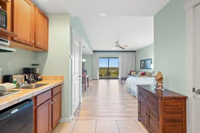 a kitchen with a sink and a bed in a room at Origin 1319 - Studio King - City View - Amazing Value by Beach Haven Vacation Rentals in Panama City Beach