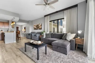 a living room with a couch and a table at Origin 1217 - One Bedroom - Partial Gulf View by Beach Haven Vacation Rentals in Panama City Beach