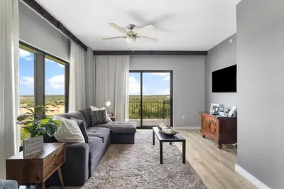 a living room with a couch and a tv at Origin 1217 - One Bedroom - Partial Gulf View by Beach Haven Vacation Rentals in Panama City Beach