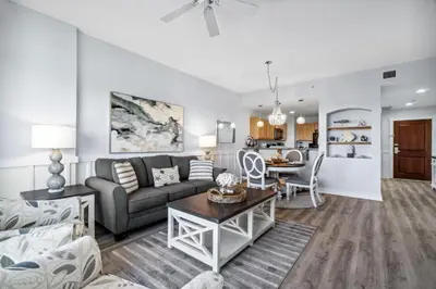 a living room with a couch and a table at Origin 1211 - One Bedroom - Spacious Partial Gulf View by Beach Haven Vacation Rentals in Panama City Beach