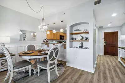 a kitchen and dining room with a table and chairs at Origin 1211 - One Bedroom - Spacious Partial Gulf View by Beach Haven Vacation Rentals in Panama City Beach