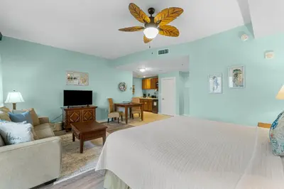 a bedroom with a bed and a living room at Origin 1129 - Studio King Gulf View - Partial Gulf View by Beach Haven Vacation Rentals in Panama City Beach