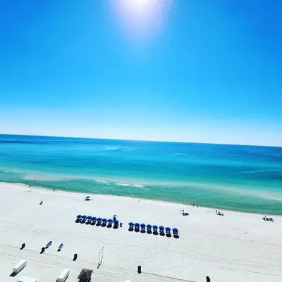 a view of a beach with chairs and the ocean at Origin 1125 - Studio King - Peaceful Nature View Unit by Beach Haven Vacation Rentals in Panama City Beach