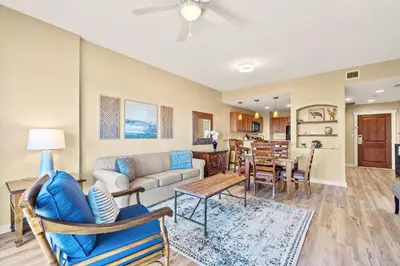 a living room with a couch and a table at Origin 1111 - One Bedroom - Cozy Partial Gulf View by Beach Haven Vacation Rentals in Panama City Beach