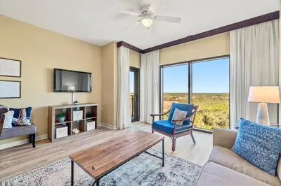 a living room with a couch and a table at Origin 1111 - One Bedroom - Cozy Partial Gulf View by Beach Haven Vacation Rentals in Panama City Beach
