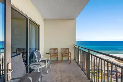 a balcony with chairs and a view of the ocean at Origin 1107- One Bedroom - Gorgeous Gulf & Sunset Views by Beach Haven Vacation Rentals in Panama City Beach