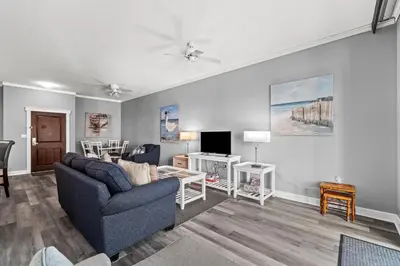 a living room with a couch and a tv at Origin 1032 - One Bedroom - Pool and Gulf Views by Beach Haven Vacation Rentals in Panama City Beach