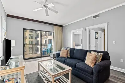 a living room with a couch and a tv at Origin 1032 - One Bedroom - Pool and Gulf Views by Beach Haven Vacation Rentals in Panama City Beach