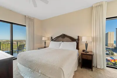 a bedroom with a bed and a large window at Origin 1027 - One Bedroom - Nature and Partial Gulf Views by Beach Haven Vacation Rentals in Panama City Beach