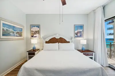 a white bedroom with a large bed and two lamps at Origin 1024 - One Bedroom - Sunny Pool Deck & Gulf Views by Beach Haven Vacation Rentals in Panama City Beach