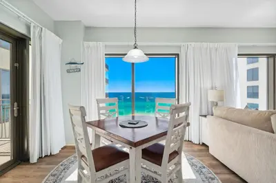 a dining room with a table and a view of the ocean at Origin 1024 - One Bedroom - Sunny Pool Deck & Gulf Views by Beach Haven Vacation Rentals in Panama City Beach