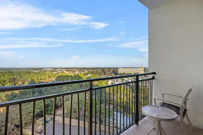 a balcony with a table and chair and a view at Origin 1023 - Studio King - Peaceful Nature View Unit by Beach Haven Vacation Rentals in Panama City Beach