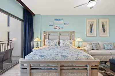 a bedroom with a bed and a couch at Origin 1013 - Studio King - Peaceful Nature View by Beach Haven Vacation Rentals in Panama City Beach