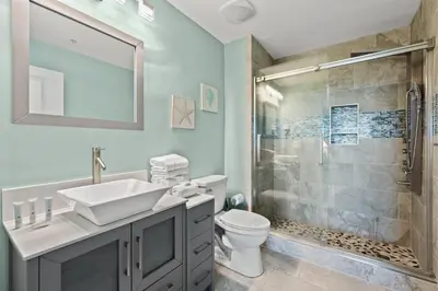 a bathroom with a toilet and a sink and a shower at Origin 1013 - Studio King - Peaceful Nature View by Beach Haven Vacation Rentals in Panama City Beach