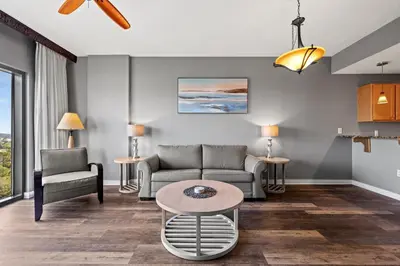 a living room with a couch and a table at Origin 1011 - One Bedroom - Spacious Partial Gulf View by Beach Haven Vacation Rentals in Panama City Beach