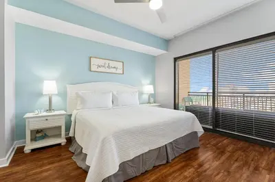 a bedroom with a white bed and a large window at Origin 1007 - One Bedroom - Sunset View by Beach Haven Vacation Rentals in Panama City Beach