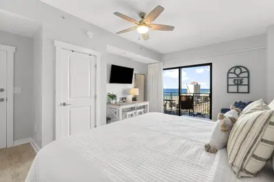a white bedroom with a bed and a window at Origin 1005 - Studio King - Stunning Gulf Views by Beach Haven Vacation Rentals in Panama City Beach