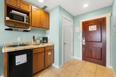 a kitchen with a sink and a microwave at Origin 0915 - Studio King - Cozy Nature View by Beach Haven Vacation Rentals in Panama City Beach