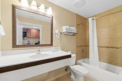 a bathroom with a sink and a toilet and a mirror at Origin 0833 - Studio King - Sunrise & Gulf View by Beach Haven Vacation Rentals in Panama City Beach
