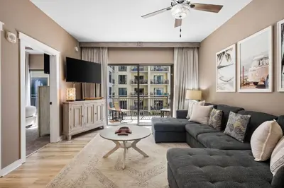a living room with a couch and a tv at Origin 0808 - One Bedroom - Sunny Pool Deck & Gulf Views! by Beach Haven Vacation Rentals in Panama City Beach