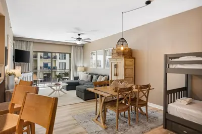 a living room with a table and a couch at Origin 0808 - One Bedroom - Sunny Pool Deck & Gulf Views! by Beach Haven Vacation Rentals in Panama City Beach
