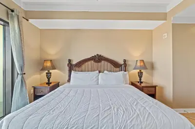 a bedroom with a large bed with two lamps at Origin 0731- One Bedroom - Sunny Gulf Views by Beach Haven Vacation Rentals in Panama City Beach