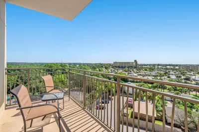 a balcony with chairs and a view of a city at Origin 0729 - Studio King - Sunrise Gulf View by Beach Haven Vacation Rentals in Panama City Beach