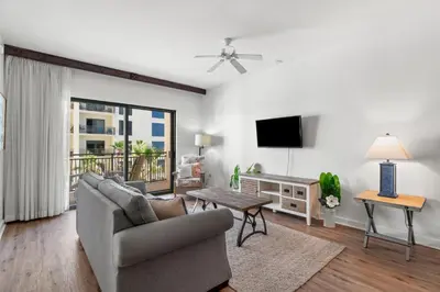 a living room with a couch and a tv at Origin 0708 - One Bedroom - Pool and Gulf Views by Beach Haven Vacation Rentals in Panama City Beach