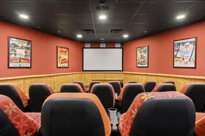 a conference room with red walls and a screen at Origin 0707 - One Bedroom - Stunning Sunset Views by Beach Haven Vacation Rentals in Panama City Beach
