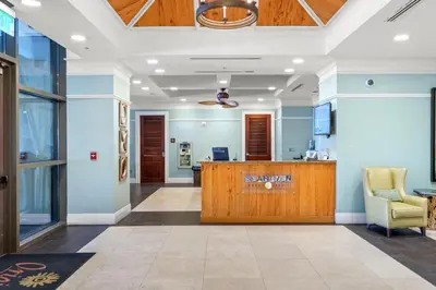 an office lobby with a reception desk and a chair at Origin 0707 - One Bedroom - Stunning Sunset Views by Beach Haven Vacation Rentals in Panama City Beach