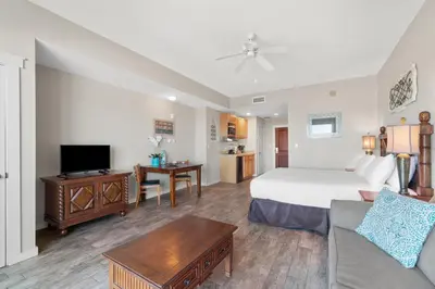 a hotel room with a bed and a living room at Origin 0705 - Studio King Gulf View- Stunning Sunset Views by Beach Haven Vacation Rentals in Panama City Beach