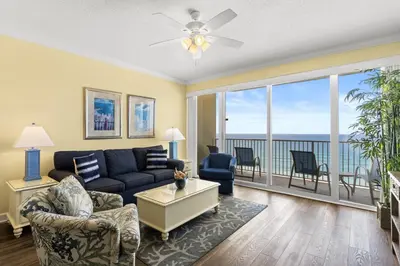 a living room with a couch and a view of the ocean at Boardwalk Beach Resort #1107 by Book That Condo in Panama City Beach