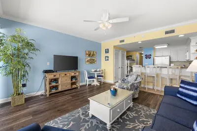 a living room with a couch and a table at Boardwalk Beach Resort #1107 by Book That Condo in Panama City Beach