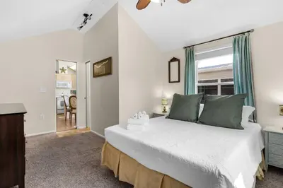 a bedroom with a large bed and a window at The Love Shack (2/2) in Panama City Beach