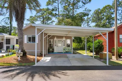 a house with a pavilion on a driveway at The Love Shack (2/2) in Panama City Beach