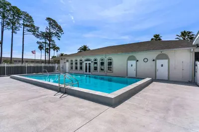 a swimming pool in front of a building at The Love Shack (2/2) in Panama City Beach