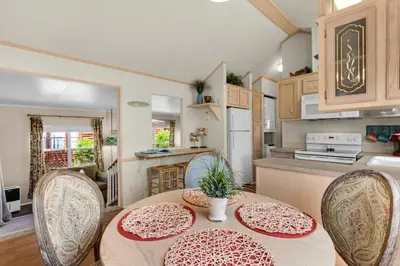 a kitchen and dining room with a table and chairs at The Love Shack (2/2) in Panama City Beach