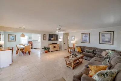 a living room with a couch and a table at Boat dock and jet ski pad! bring your boat! in Panama City Beach