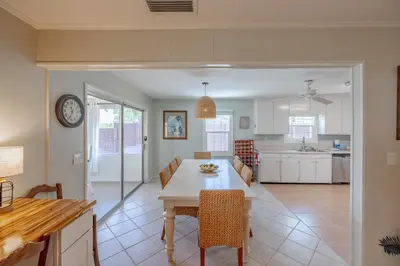 a kitchen and dining room with a table and chairs at Boat dock and jet ski pad! bring your boat! in Panama City Beach