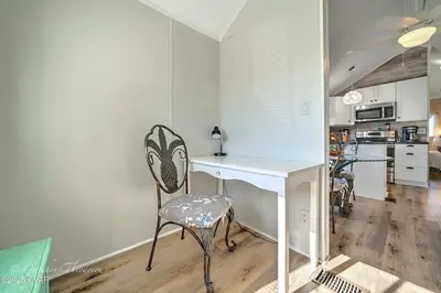 a kitchen with a desk and a chair in a room at Enjoy your quiet vacation at Butler's Beach Retreat! in Panama City Beach