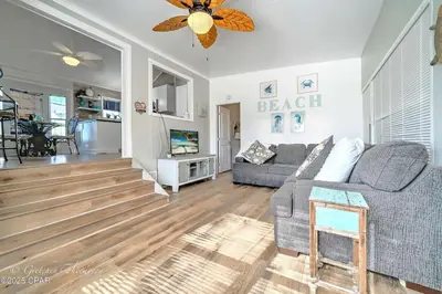 a living room with a couch and a television at Enjoy your quiet vacation at Butler's Beach Retreat! in Panama City Beach