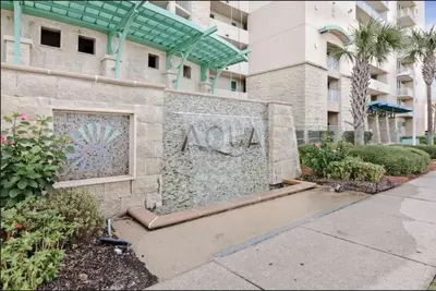 a wall with a painting on the side of a building at Aqua 403 - Free Beach Chairs! Indoor/Outdoor Pool! in Panama City Beach